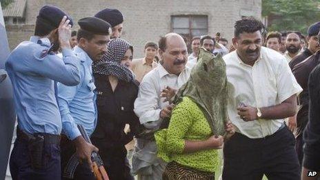 "Rimsha" is escorted to a helicopter after being released form jail in Rawalpindi, Pakistan, 8 September 2012