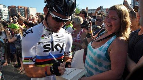 Mark Cavendish signs a book for a fan in Ipswich