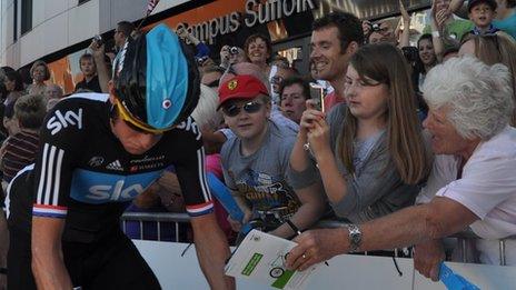 Bradley Wiggins cycles past fans at the start of the Tour of Britain 2012