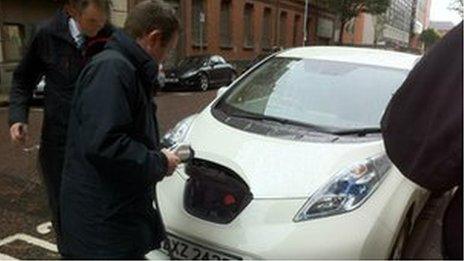 BBC reporter Conor Macauley plugging in the Ecar