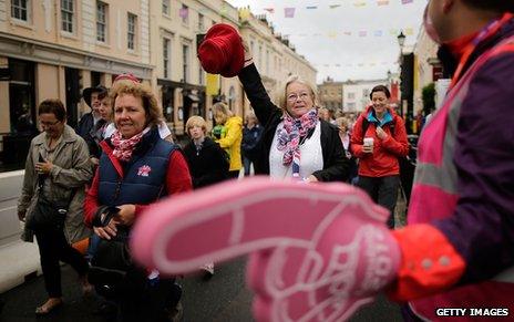 Spectators are guided by volunteers