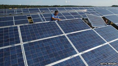 Workers installing panels at a solar park