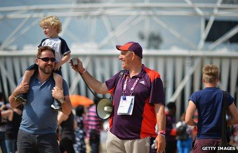 Olympic volunteer jokes with spectators