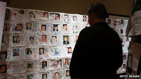 Pictures of loved ones killed in the 9/11 attacks, that were made by family members, are displayed at a preview of the National September 11 Memorial Museum’s memorial exhibition in New York City on 10 September 2012