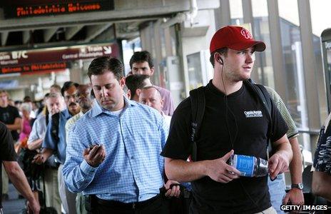 Airport passengers holding bottled water