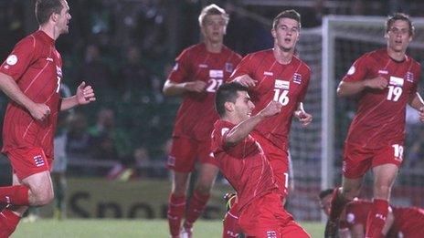 Luxembourg players run to congratulate Daniel da Mota after the late own goal