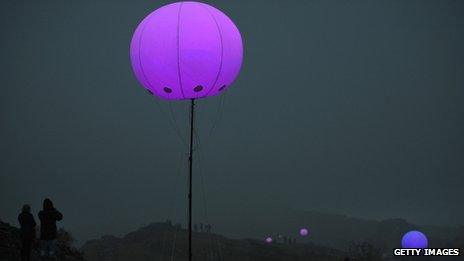 Members of the public view the art installation Connecting Light by New York based digital arts collective YesYesNo - part of the London 2012 Festival