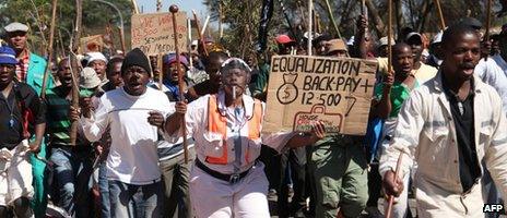 Striking miners march on 11 September 2012 in Carletonville, west of Johannesburg.