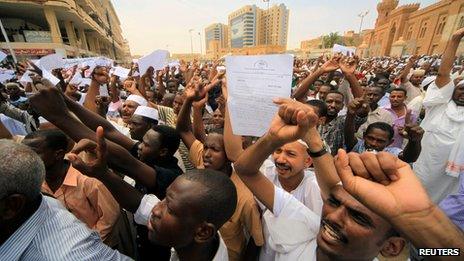 Sudanese demonstrators walk out after Friday prayers to protest in front of the the German and US embassies in Khartoum on Friday