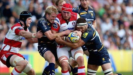 Gloucester's Ben Morgan is tackled by Worcester duo Joe Carlisle and Sam Betty