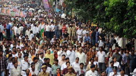 Indian activists of the Trinamool Congress (TMC) with the chief minister of the eastern Indian state of West Bengal Mamta Banerjee (unseen) march during a demonstration against the foreign direct investment (FDI) in multi-brand retail in Kolkata on September 15, 2012.