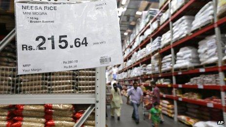 A sign gives details of savings for a particular product at a Bharti-Walmart store on the outskirts of Chandigarh, India, Sunday, Sept. 16, 2012.