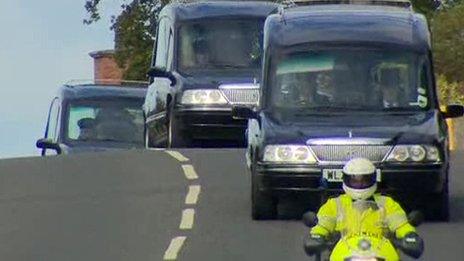 The coffins of three members of the Spence family are taken to the church