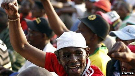 Striking miners gesture after they were informed of a 22 percent wage increase offer outside Lonmin"s Marikana mine, 100 km (60 miles) northwest of Johannesburg, September 18, 2012