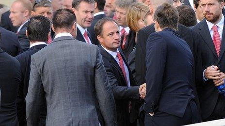 Mourners shake hands