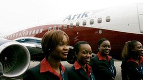 Air stewards stand outside an Arik Air plane in Seattle, US April 2007