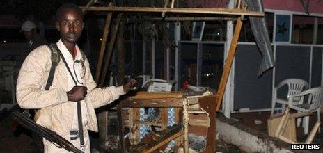 A Somali policeman in the ruins of the Village restaurant in Mogadishu, Somalia on 20 September 2012