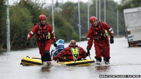 Firefighters rescue stranded motorists from a flooded road outside Castleford, West Yorkshire. Photo: Anna Gowthorpe/PA Wire