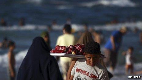 Boy selling toffee apples on the beach at Alexandria, Egypt (file photo - 7 Sept 2012)