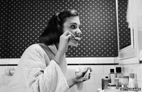 Young woman brushing her teeth in the 1930s