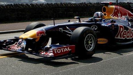 Former Red Bull Racing Formula 1 driver David Coulthard drives the Red Bull running show car for a video shoot on August 15 2012 in Weehawken