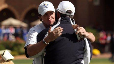 Rory Mcllroy hugs his captain Jose Maria Olazabal on the putting green after arriving late to the golf course