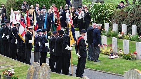 Wreaths laid on the graves of those lost in the sinking of HMS Charybdis and Limbourne in 1943 by survivors