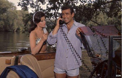 James Bond (Sean Connery) and Sylvia Trench's (Eunice Gayson) romantic encounter on the banks of the river is interrupted by a call from HQ