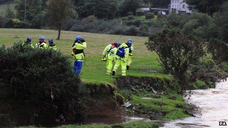 Coastguards search a river outside Machynlleth