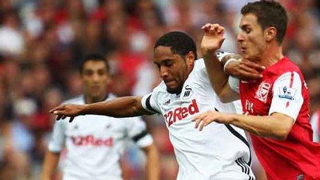 Ashley Williams and Aaron Ramsey compete for their clubs