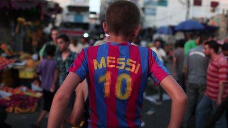 Palestinian boy on motorbike with Messi shirt