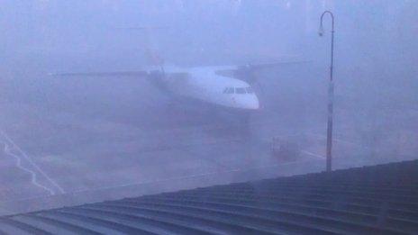 An aircraft at a foggy airport