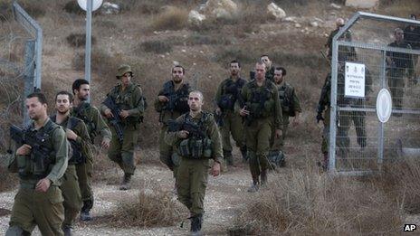 Israeli soldiers are seen after searching for the remains of a drone in the Negev southern Israel