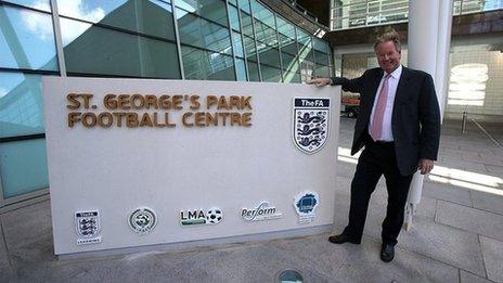 David Sheepshanks poses for photos outside the St George's Park Football Centre