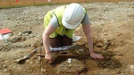 An archaeologist excavating a Bronze Age crematorium