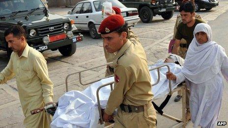 Soldiers carry Malala Yousafzai, 14, at an army hospital following the attack