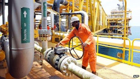 A file photo taken on April 14, 2009 shows a worker inspecting facilities on an upstream oil drilling platform at the Total oil platform at Amenem, 35 kilometres away from Port Harcourt, Nigeria.