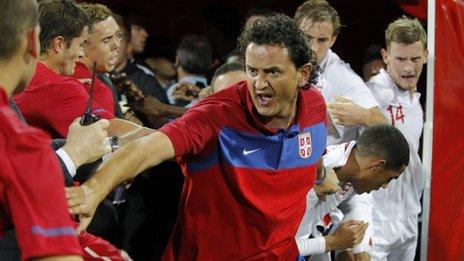 Assistant coach Dejan Govedarica (C) of Serbia attempts to keep the opposing players apart during a scuffle