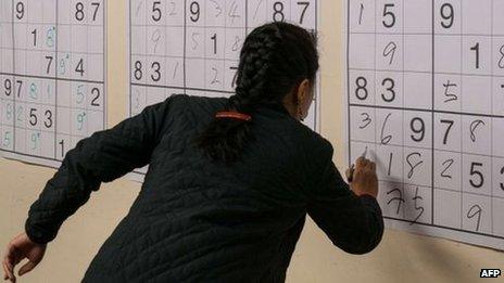 Woman doing sudoku