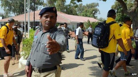 Policemen escort international cricketers after a practise session in Karachi on 19 October