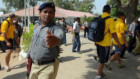 Policemen escort international cricketers after a practise session in Karachi on 19 October