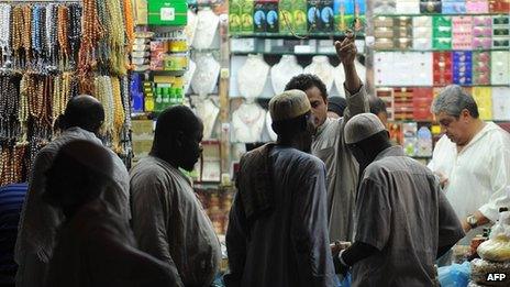 African Muslim pilgrims shop close to the Grand Mosque in the holy city of Mecca, on October 23, 2012.