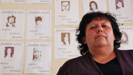 Lorena Pizarro in front of photos of the disappeared in Chile