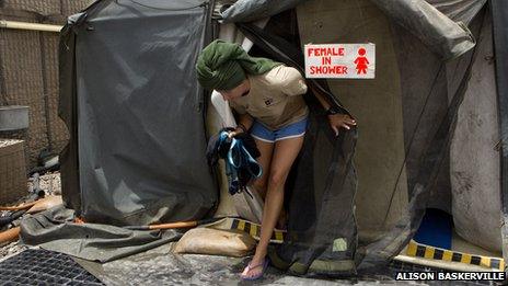 A female soldier exiting a shower tent