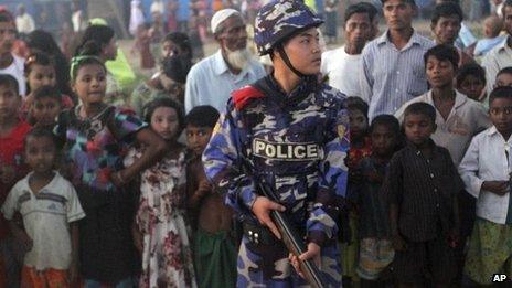 Armed policeman guards refugees at camp in Sittwe - 27 October