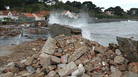 Perelle coast road with rumble used to temporarily fill the gap in the sea wall