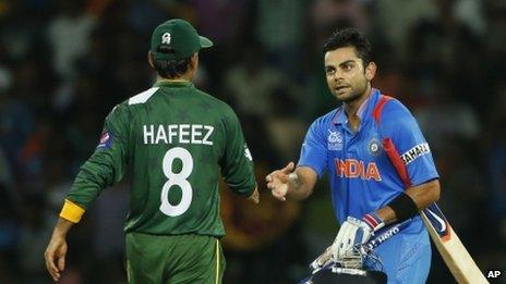 Indian batsmen Virat Kohli (right) shakes hands with Pakistan's captain Mohammad Hafeez after beating them by eight wickets in the ICC Twenty20 Cricket World Cup Super Eight match between India and Pakistan in Colombo