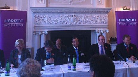 Tatsuro Ishizuka, chief executive of Hitachi's power systems company, flanked by energy executives and UK politicians