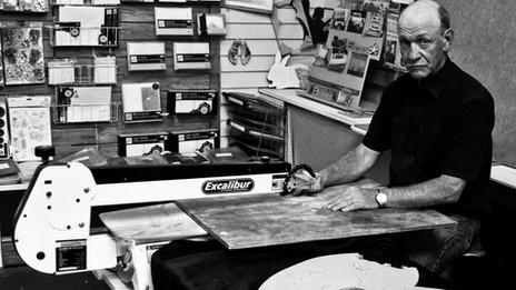 Dave Evans at his jigsaw cutting machine in his Weymouth workshop