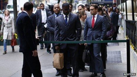 Job seekers line up at a career fair in New York City on 24 October